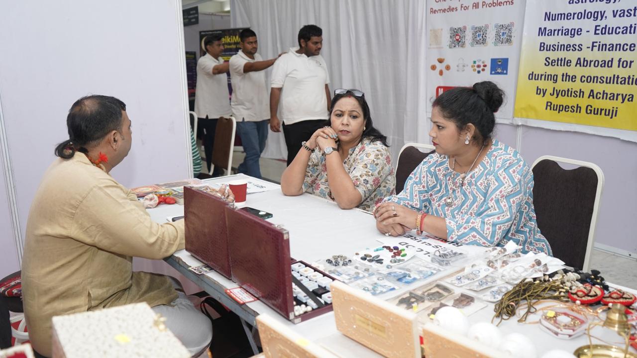 Astro Sonu Kumar with a guest at an exhibition booth